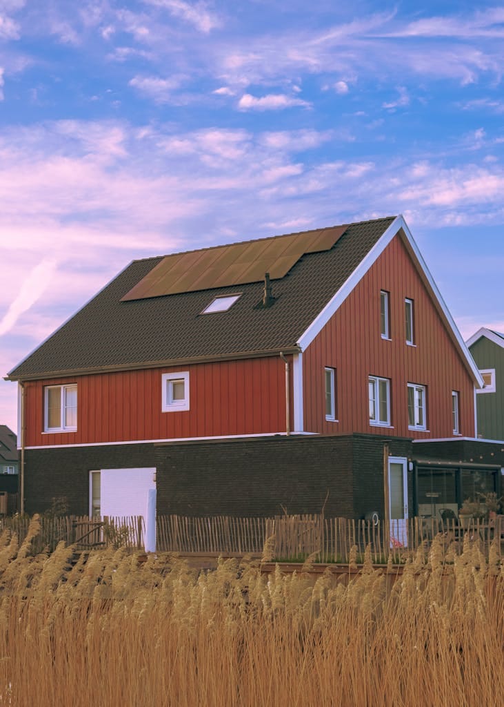 charming traditional farmhouse with solar panels under a blue sky in arnhem netherlands. 16007480 731x1024 2