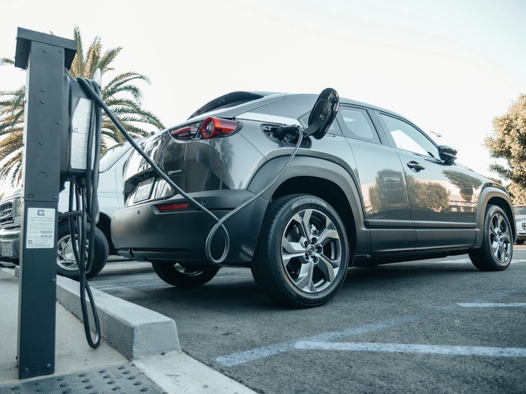 Photo by Kindel Media Modern electric vehicle charging at an outdoor station in daylight.