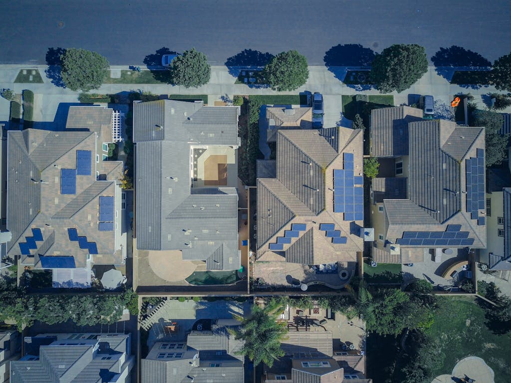 Photo by Kindel Media Top-down view of urban houses with solar power emphasizing clean energy solutions.
