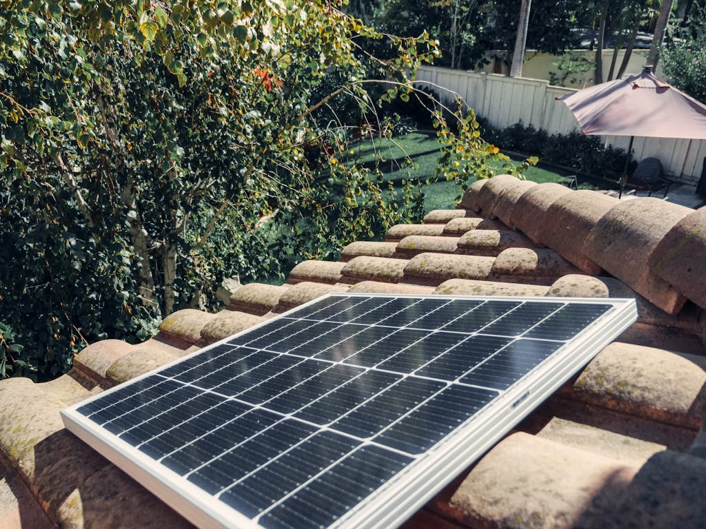 Close-up of a solar panel installed on a tiled roof, capturing clean energy.